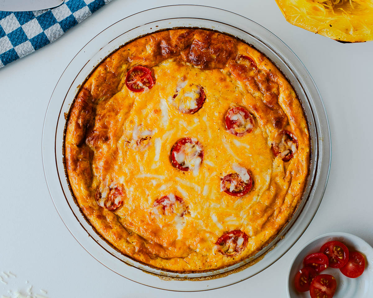 Low carb spaghetti squash crustless quiche fresh out of the oven in a glass pie dish