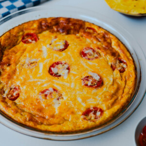 Side view of spaghetti squash crustless quiche with golden edges and melted cheese on top