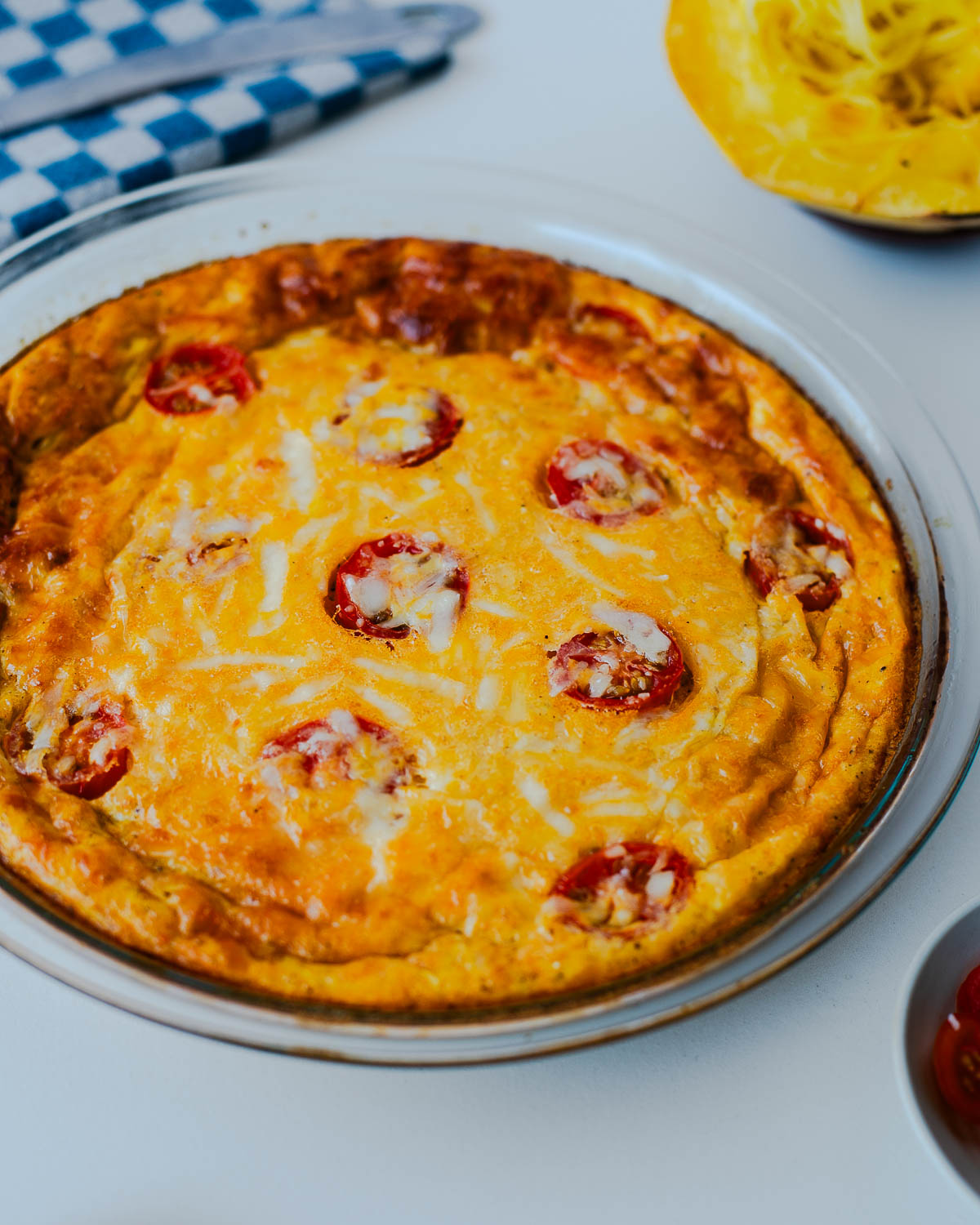 Side view of spaghetti squash crustless quiche with golden edges and melted cheese on top