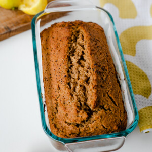 Freshly baked whole wheat lemon poppy seed loaf cooling in a glass pan