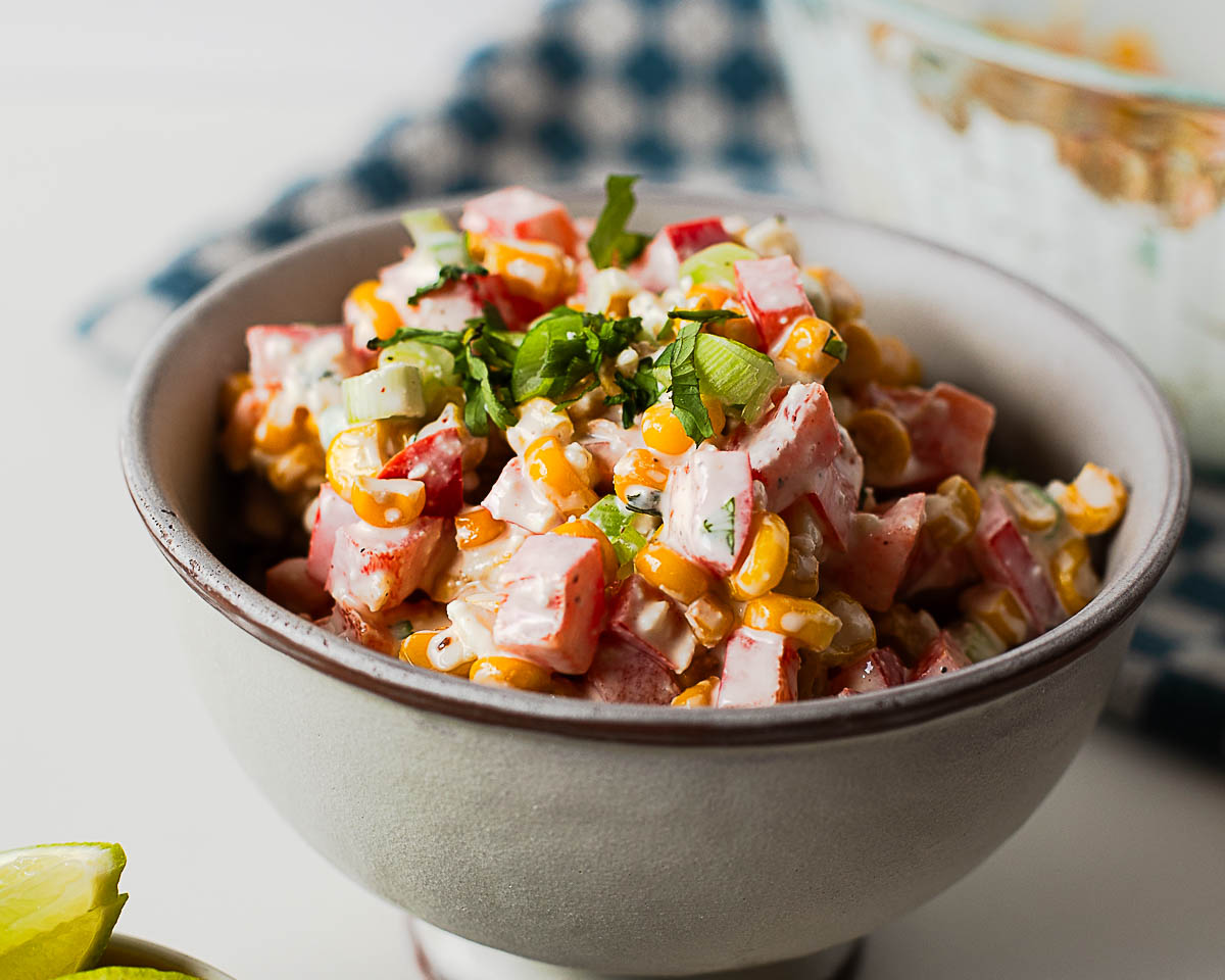 Side view of Mexican street corn salad garnished with cilantro and green onions, an easy side dish for tacos, grilled meats, and burrito bowls.