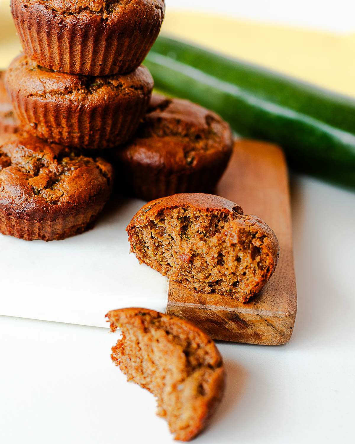 Close-up of a halved zucchini almond butter muffin showing the moist, tender crumb