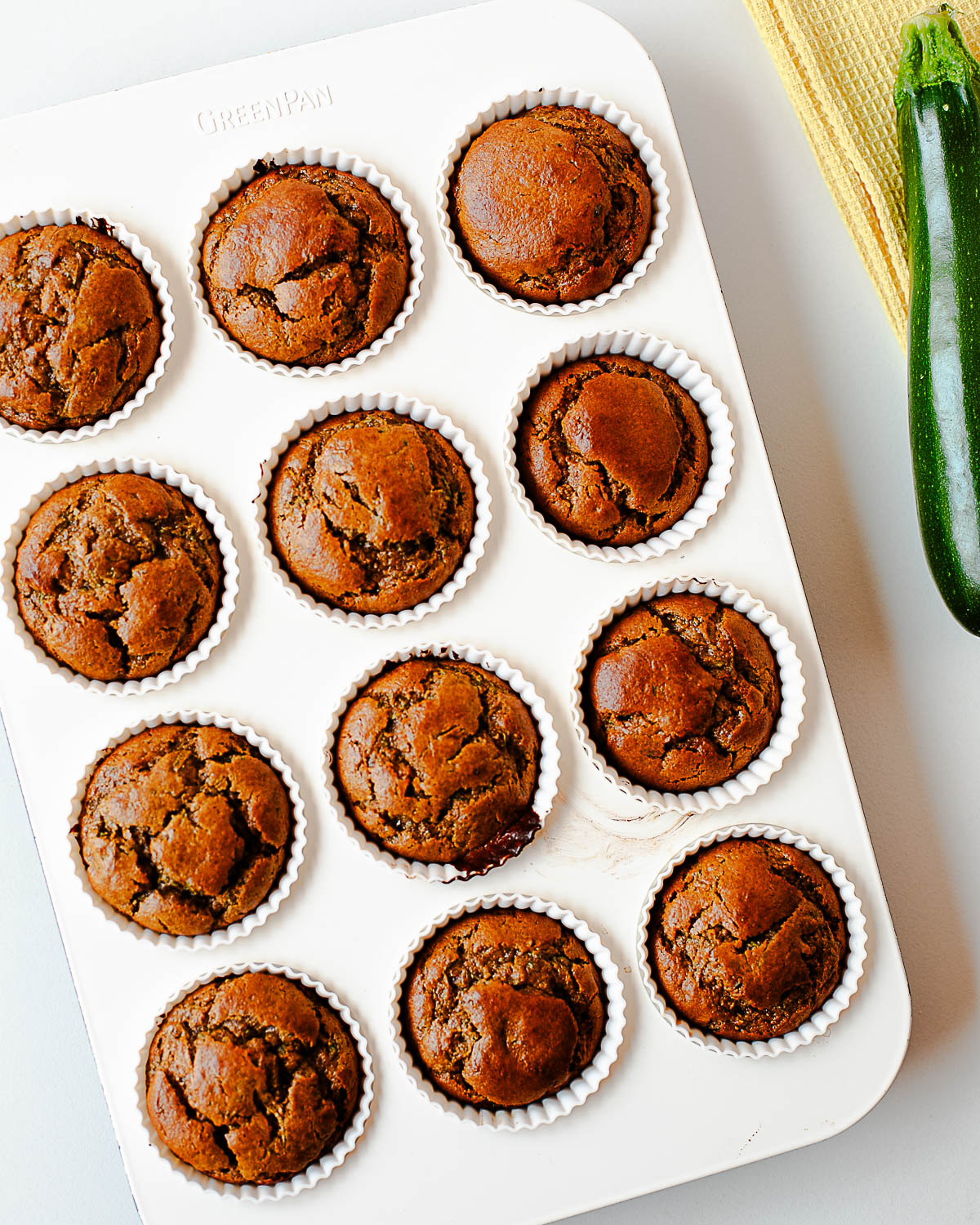 Baked almond butter zucchini muffins cooling in the muffin tin