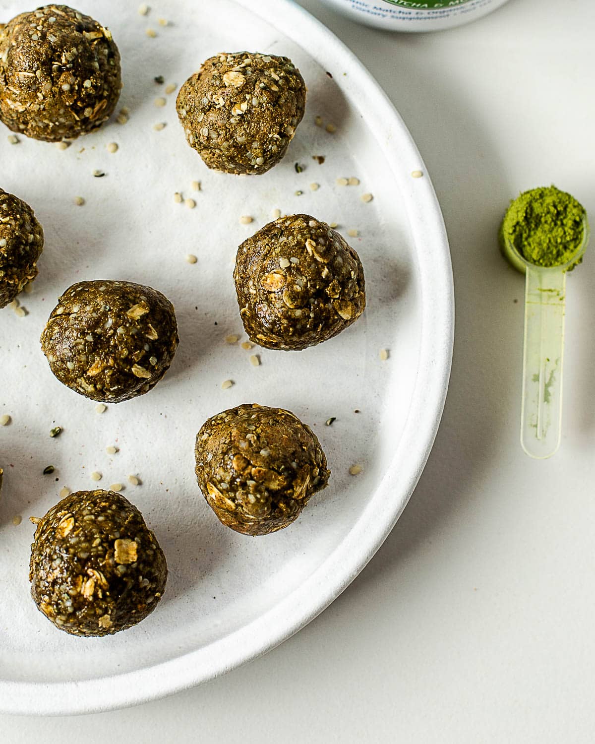 Healthy no-bake matcha protein balls made with vanilla protein powder, oats, almond butter, and matcha powder.