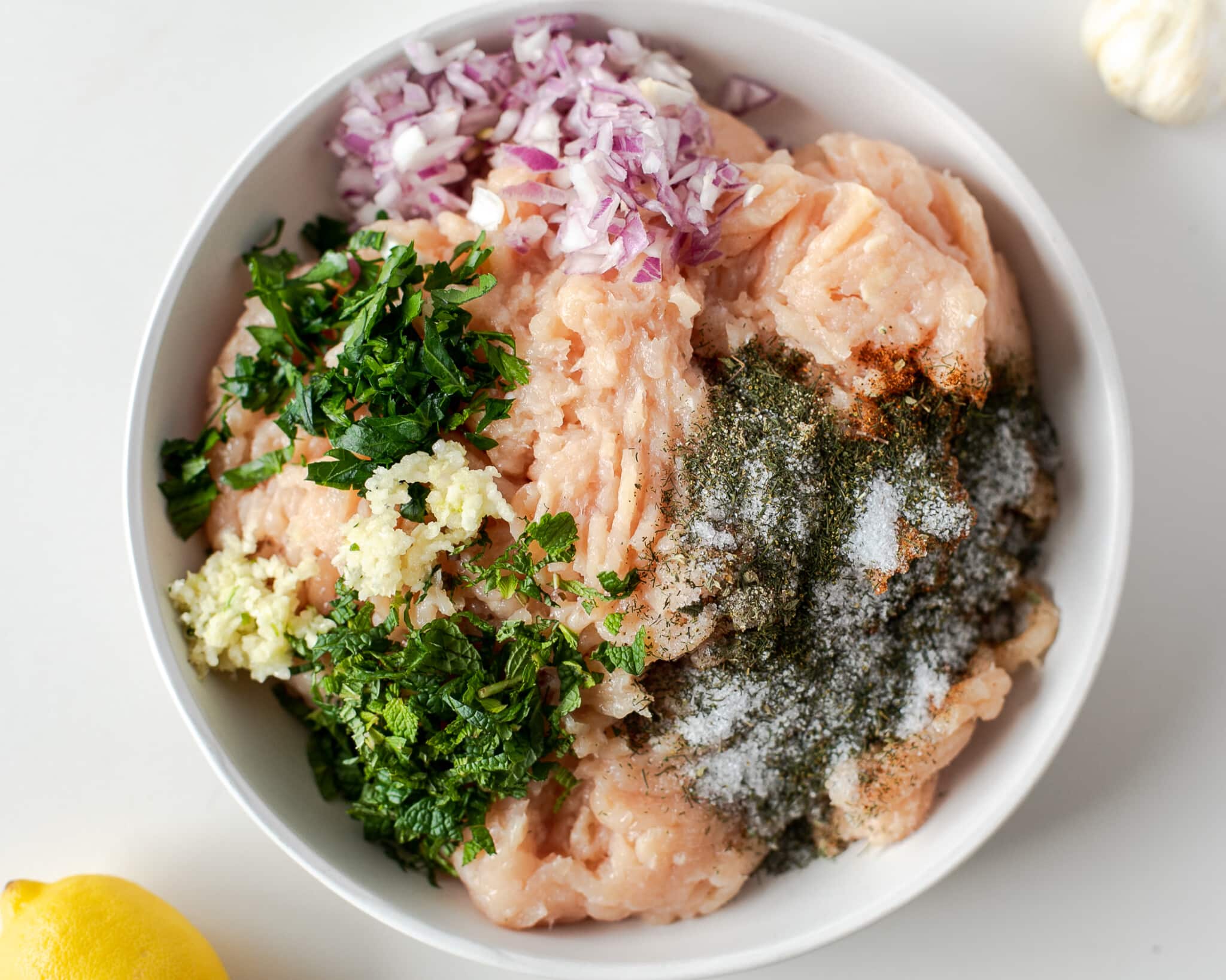 mixing up greek chicken meatballs