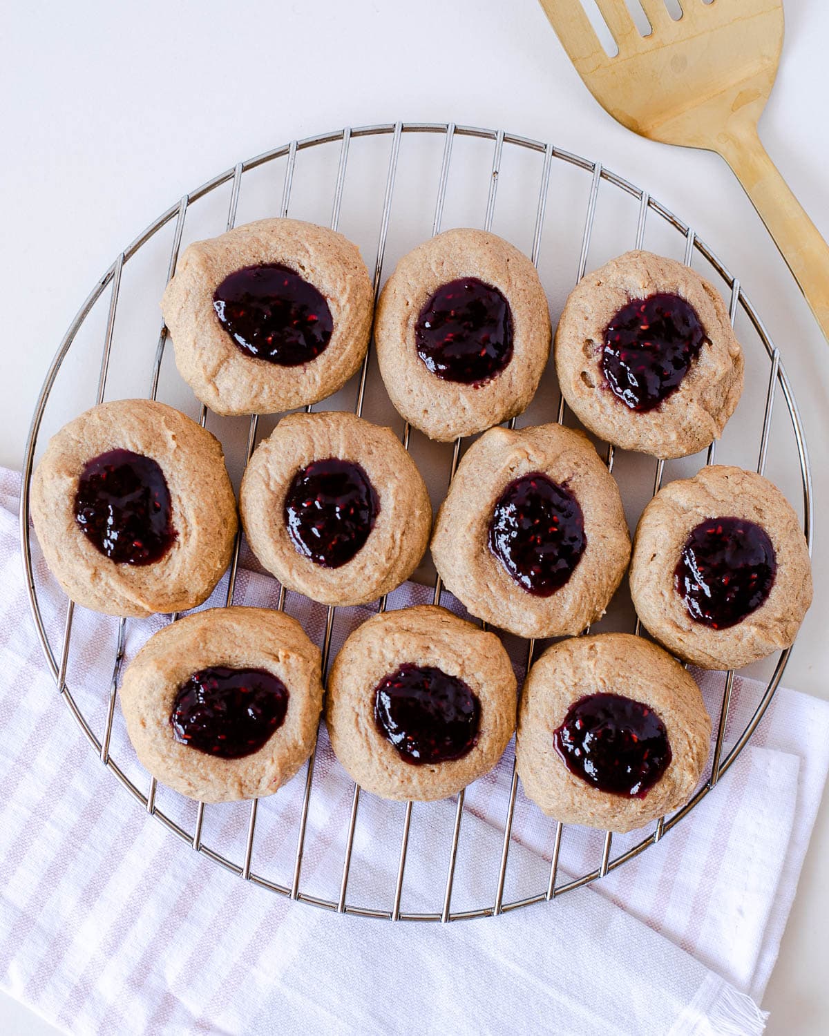 peanut butter thumbprint cookies on a cooling rack