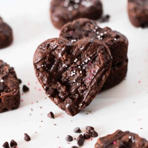 heart shaped protein brownies with chocolate chips around on a white surface