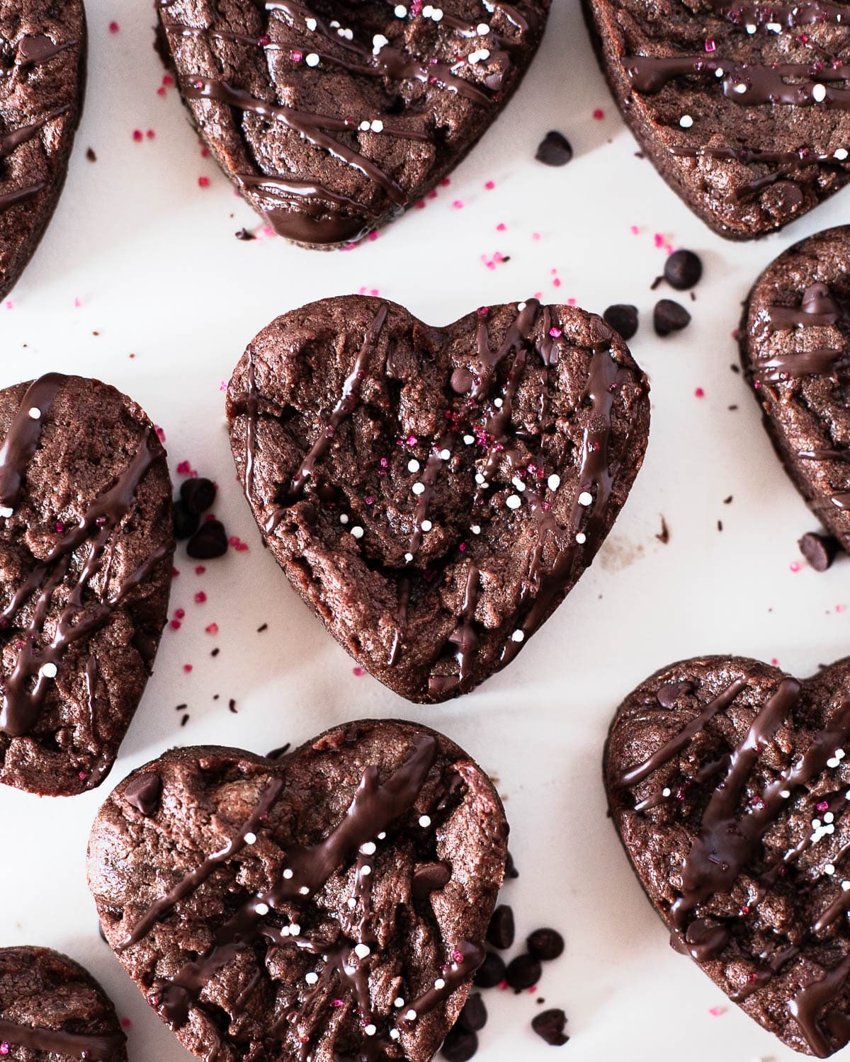 overhead shot of heart shaped protein brownies on a white surface