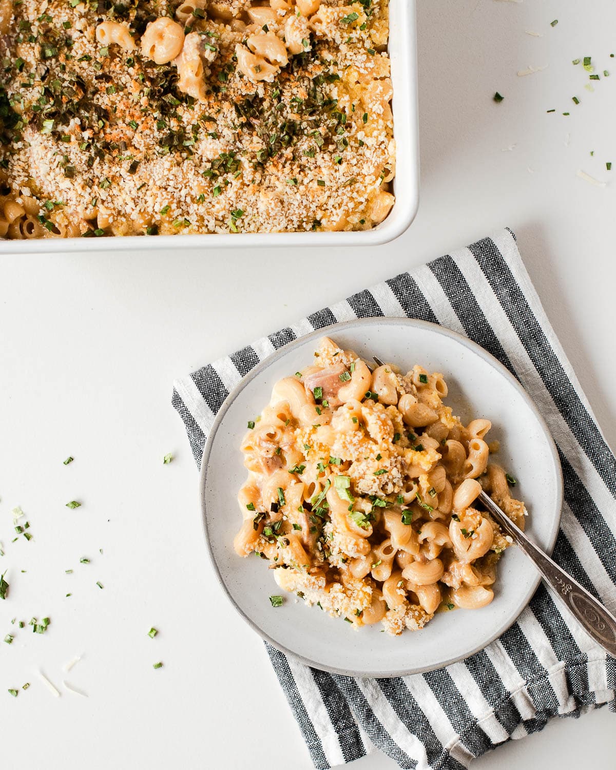 overhead of tuna mac on a white plate and in a white casserole dish