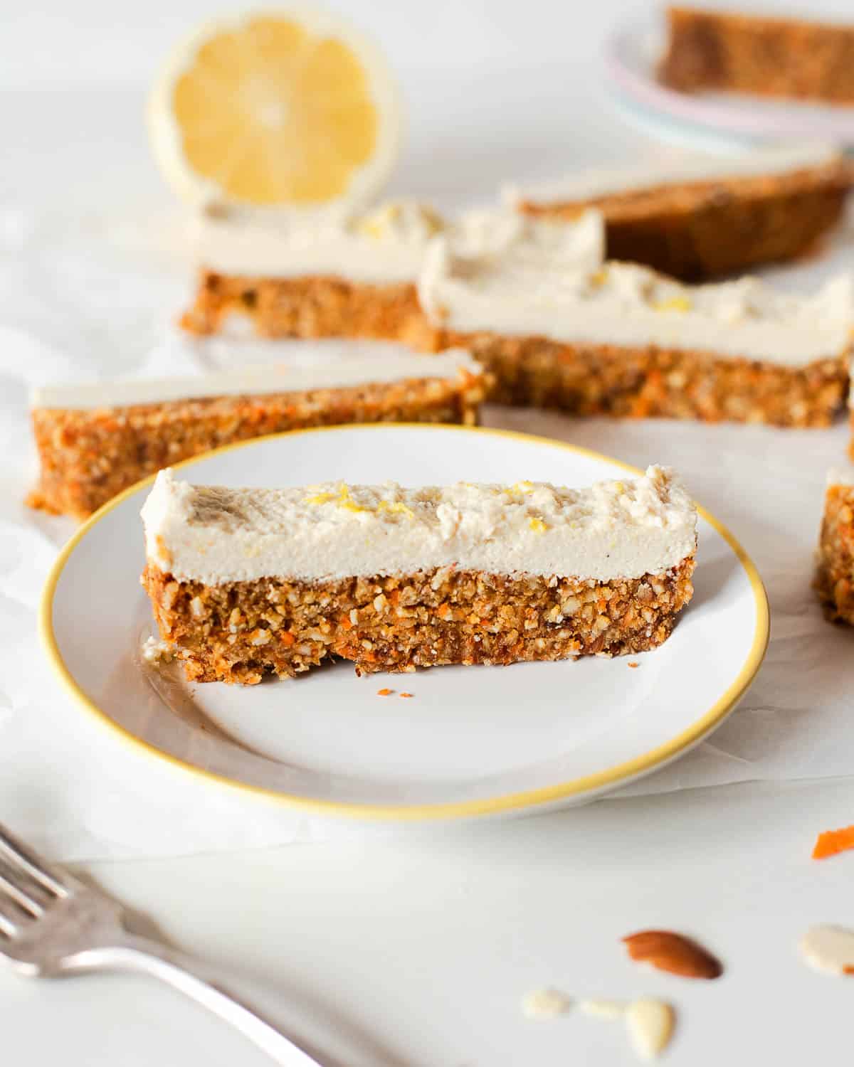 one of the freezer carrot cake bars on a plate with more around it