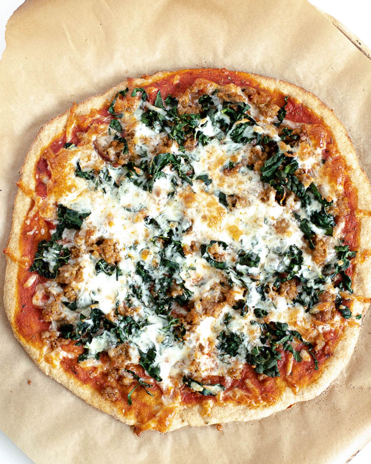 einkorn pizza with italian sausage and kale