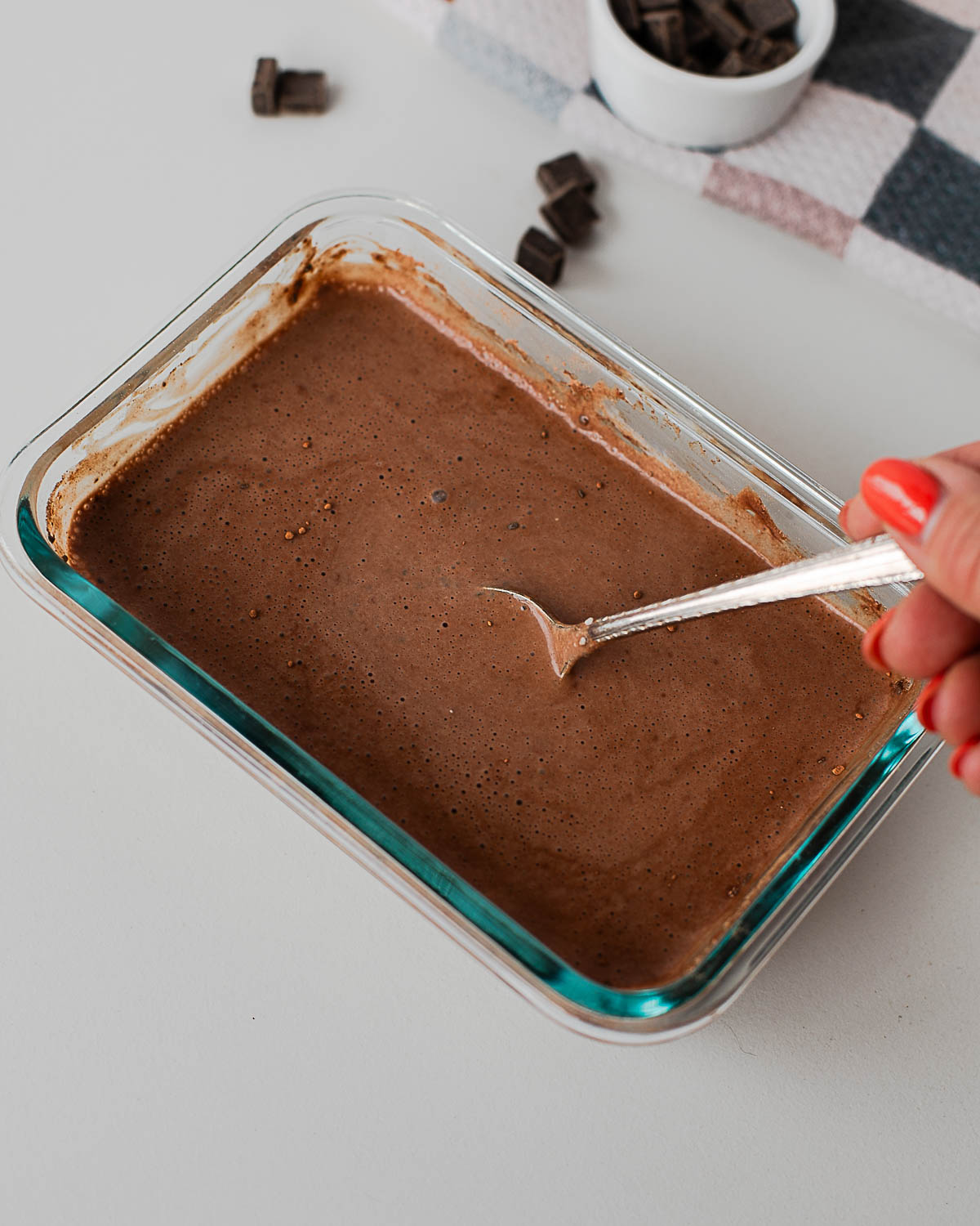 Mixing the chia pudding base in a glass dish until smooth and combined.