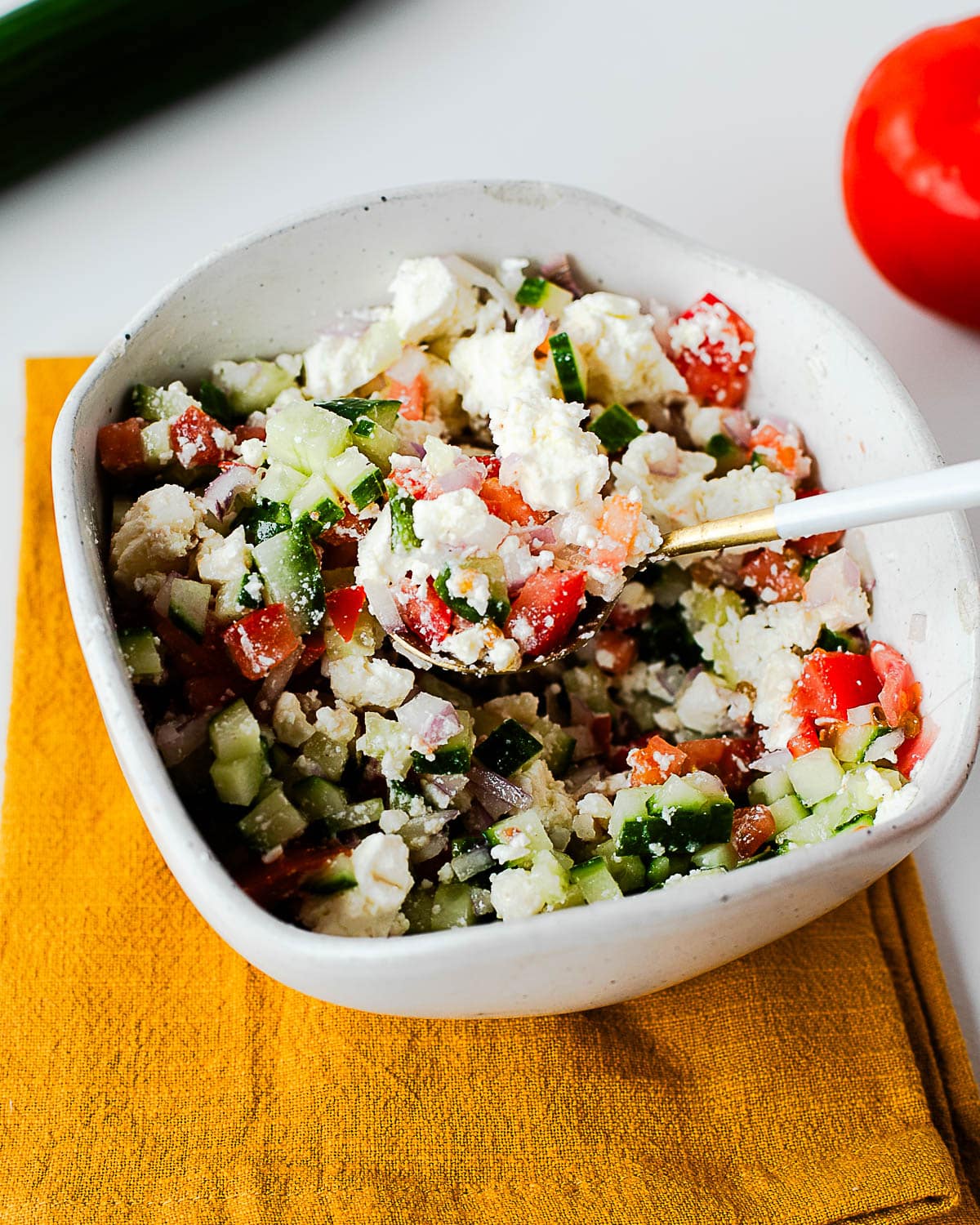 Chopped Mediterranean salad with cucumber, tomato, red onion, and feta.