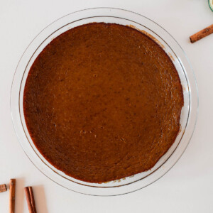 Crustless dairy free pumpkin pie just out of the oven, perfectly set with golden edges and that classic pumpkin spice aroma.