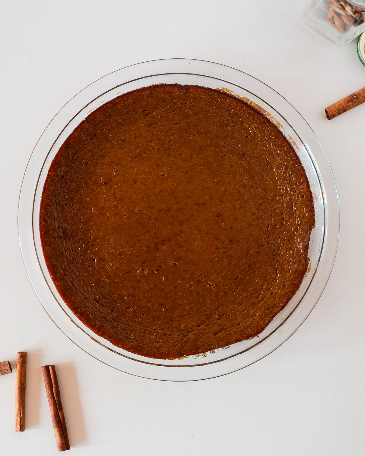Crustless dairy free pumpkin pie just out of the oven, perfectly set with golden edges and that classic pumpkin spice aroma.