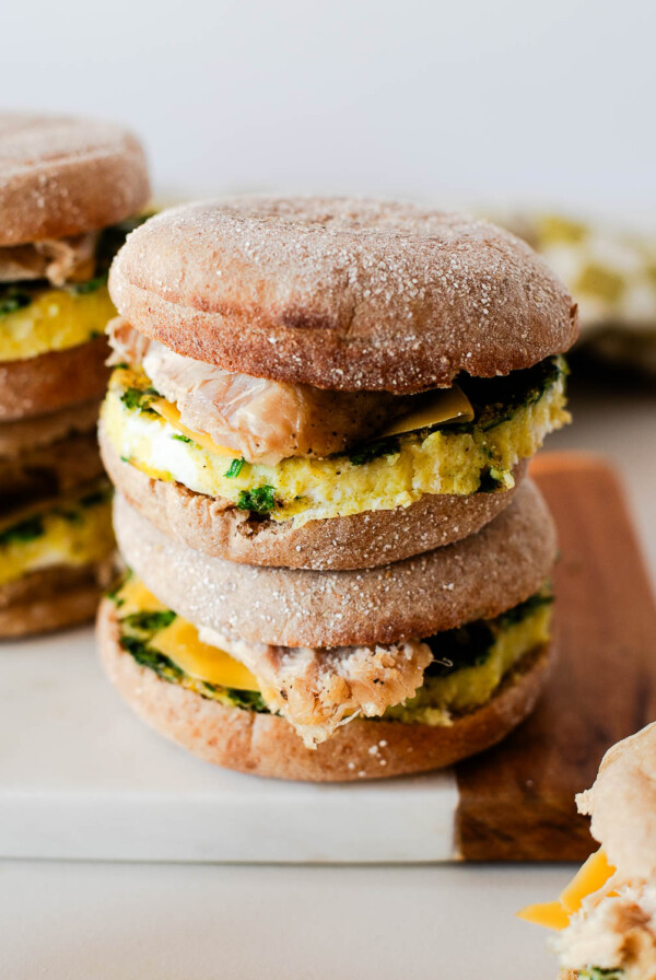 Close-up of a turkey breakfast sandwich showing the spinach egg round, melted cheddar, and toasted English muffin.