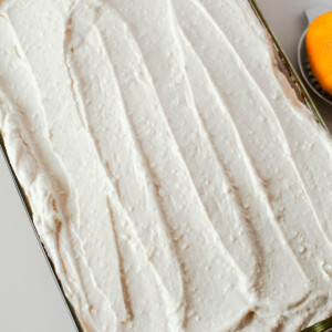 Sweet potato sheet cake fully frosted with a smooth layer of maple cream cheese frosting, creamy and slightly textured.