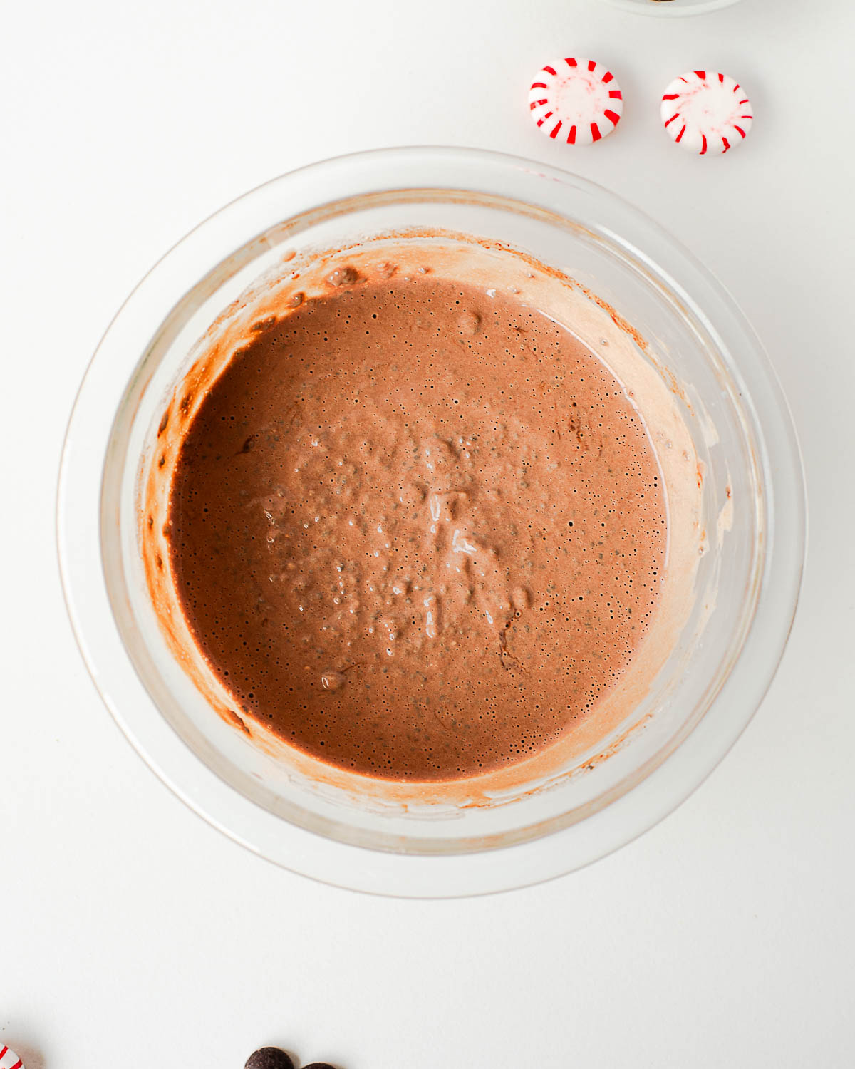 High-protein chocolate peppermint chia pudding mixture in a glass bowl before chilling