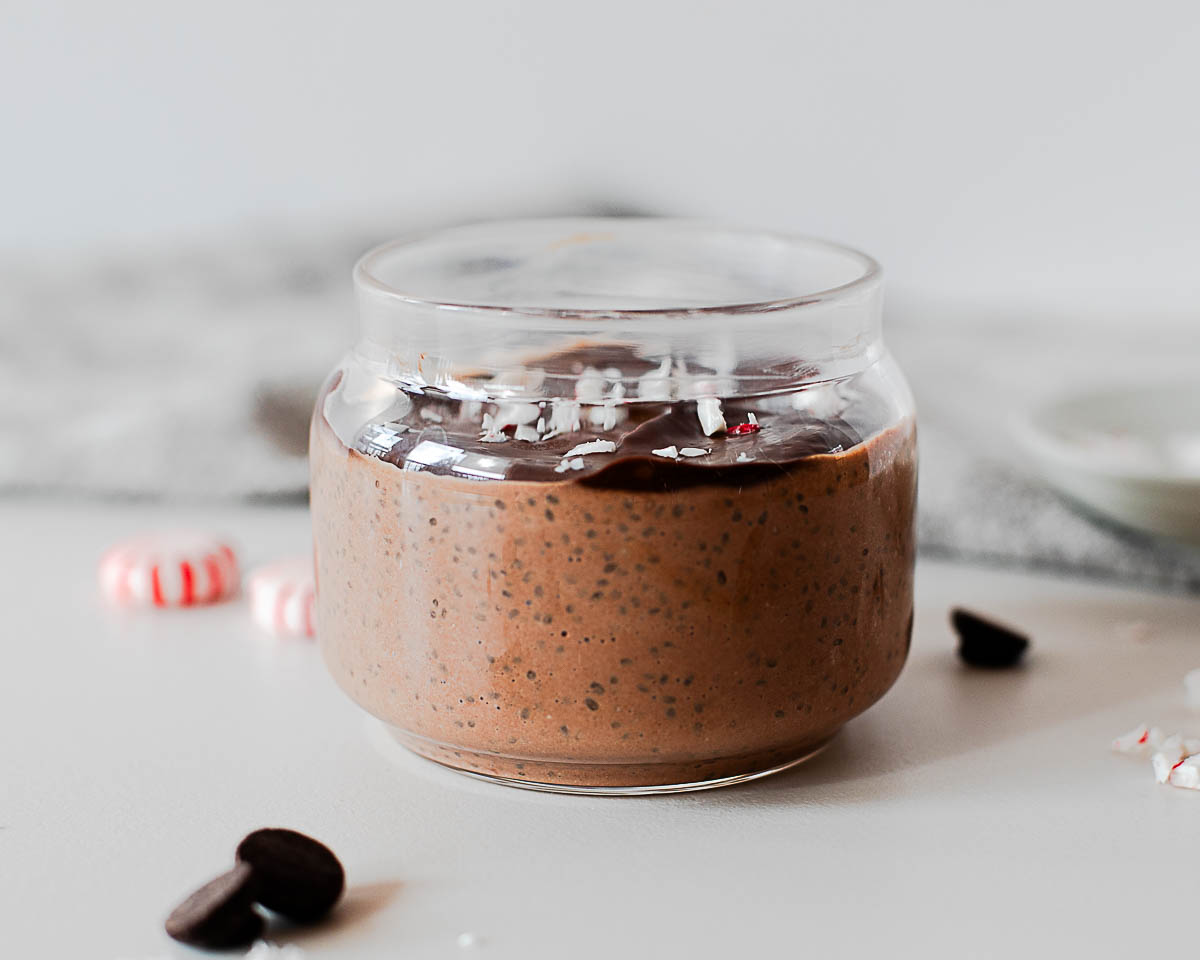 Side view of holiday chocolate peppermint chia pudding cups with chocolate topping