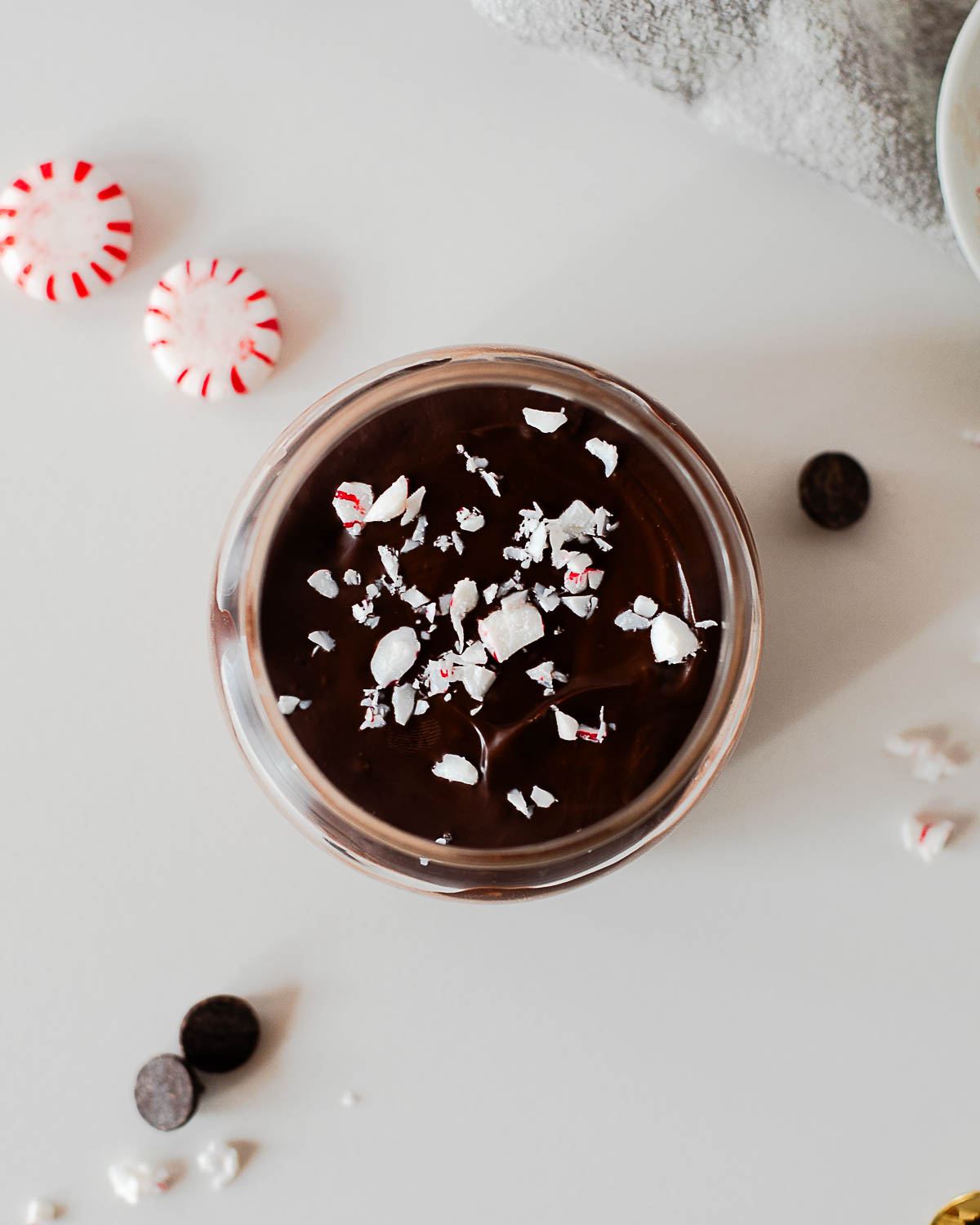 Overhead view of chocolate peppermint chia pudding topped with melted chocolate and crushed candy canes
