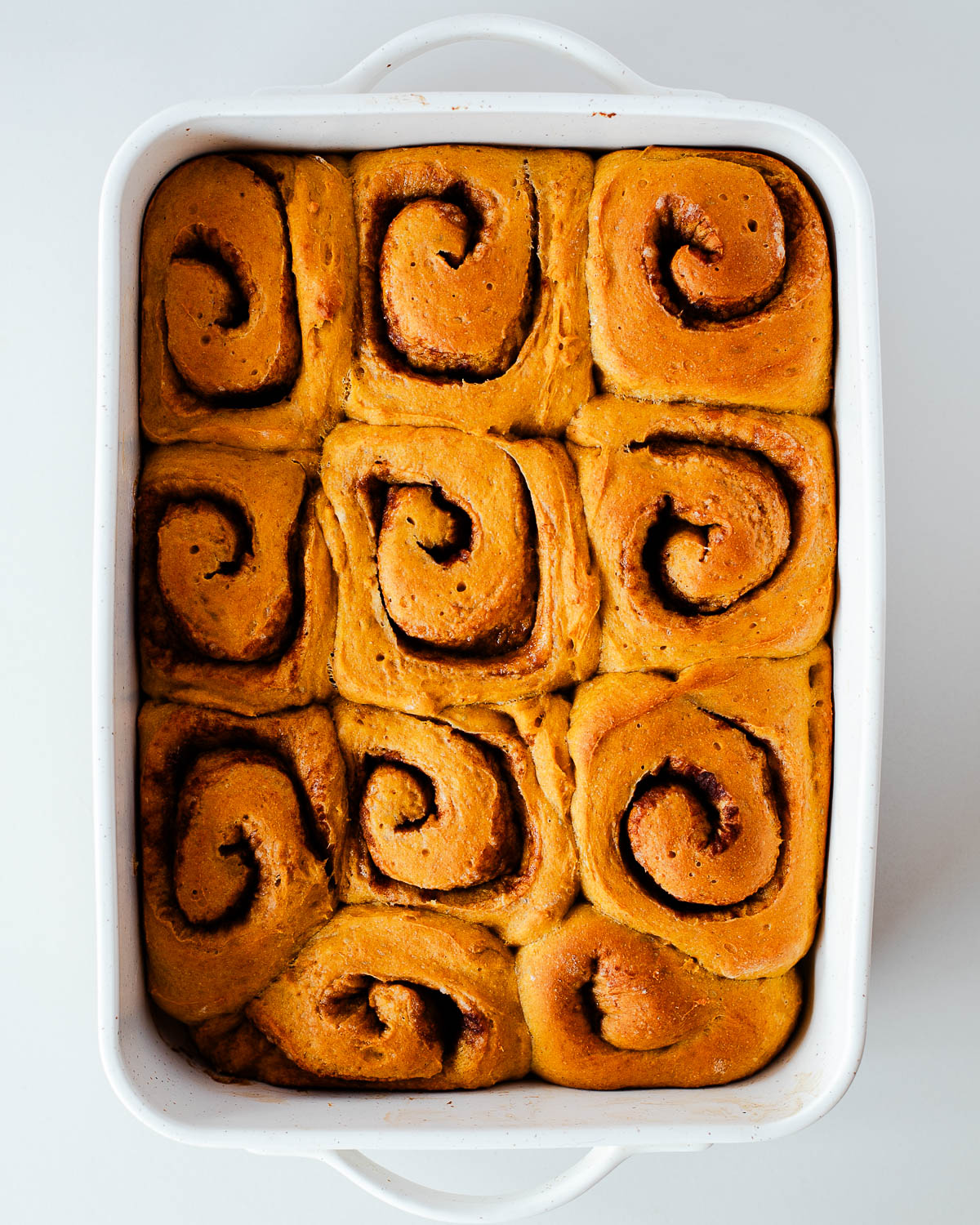 Whole wheat sweet potato cinnamon rolls fresh from the oven before icing