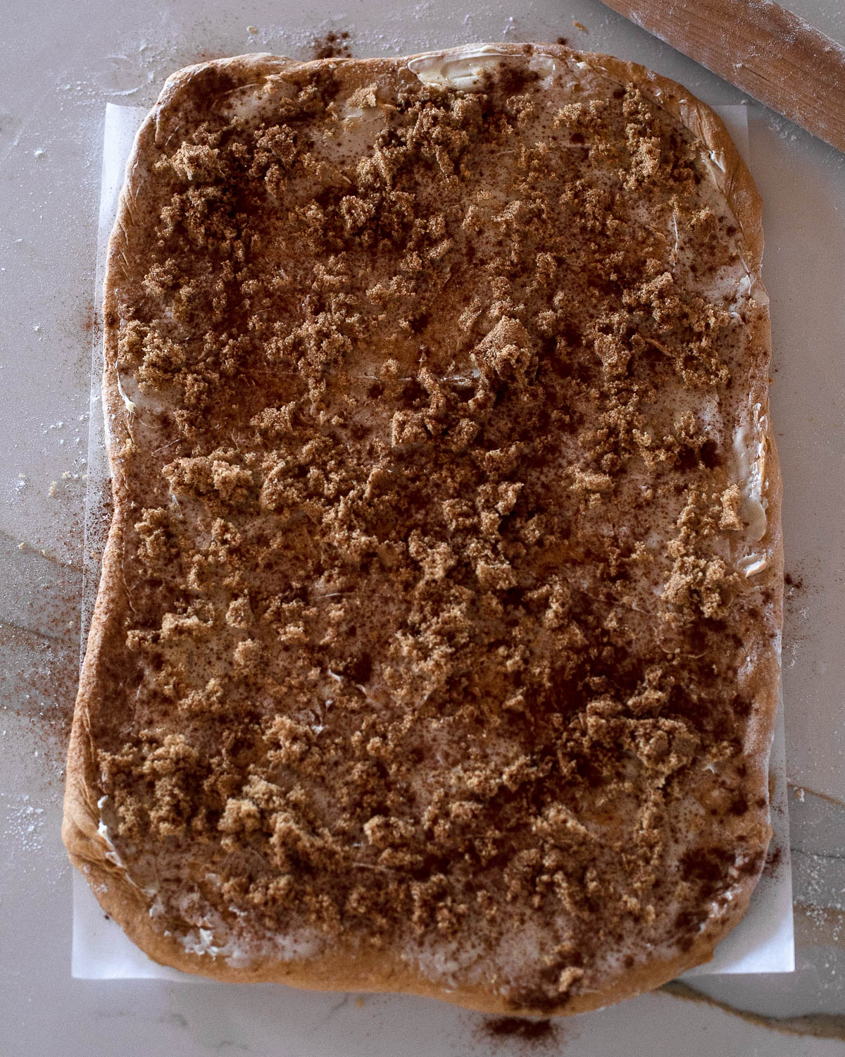 Sweet potato cinnamon roll dough spread with butter, brown sugar, and cinnamon