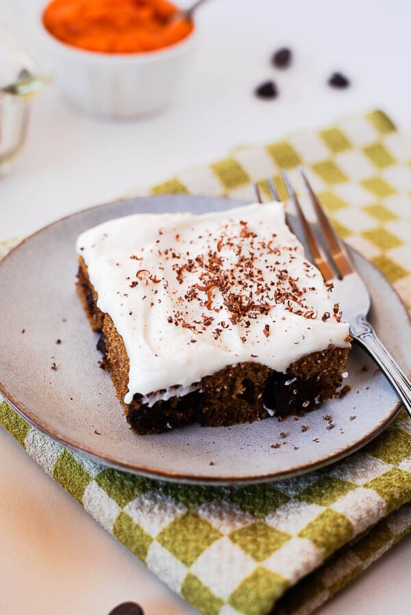 Pumpkin chocolate chip bars topped with an even layer of cream cheese frosting