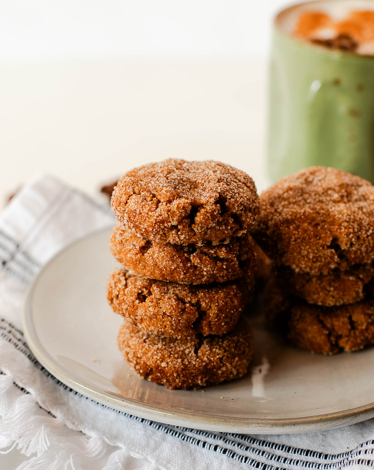 Stack of vegan sweet potato snickerdoodle cookies showing soft texture and cinnamon sugar topping