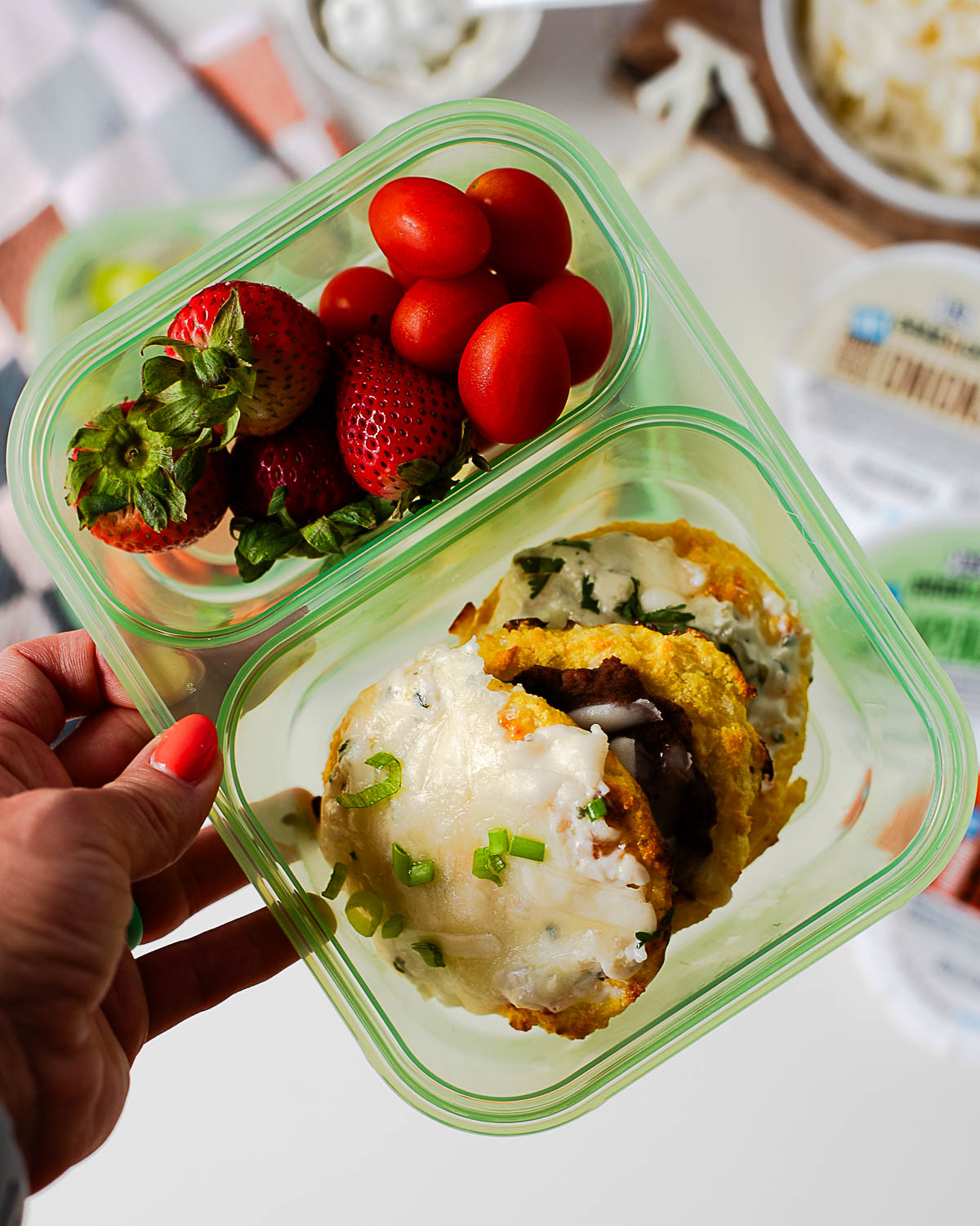 Meal prep lunchbox with cottage cheese pizza bites and fresh fruit and vegetables