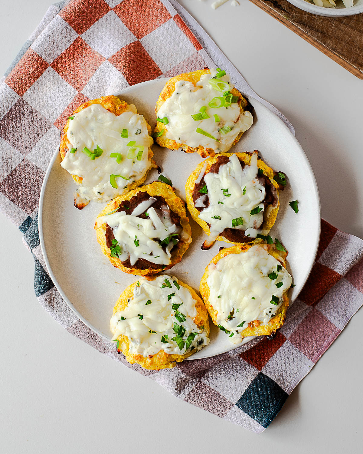 High-protein cottage cheese pizza bites served on a plate with fresh herbs
