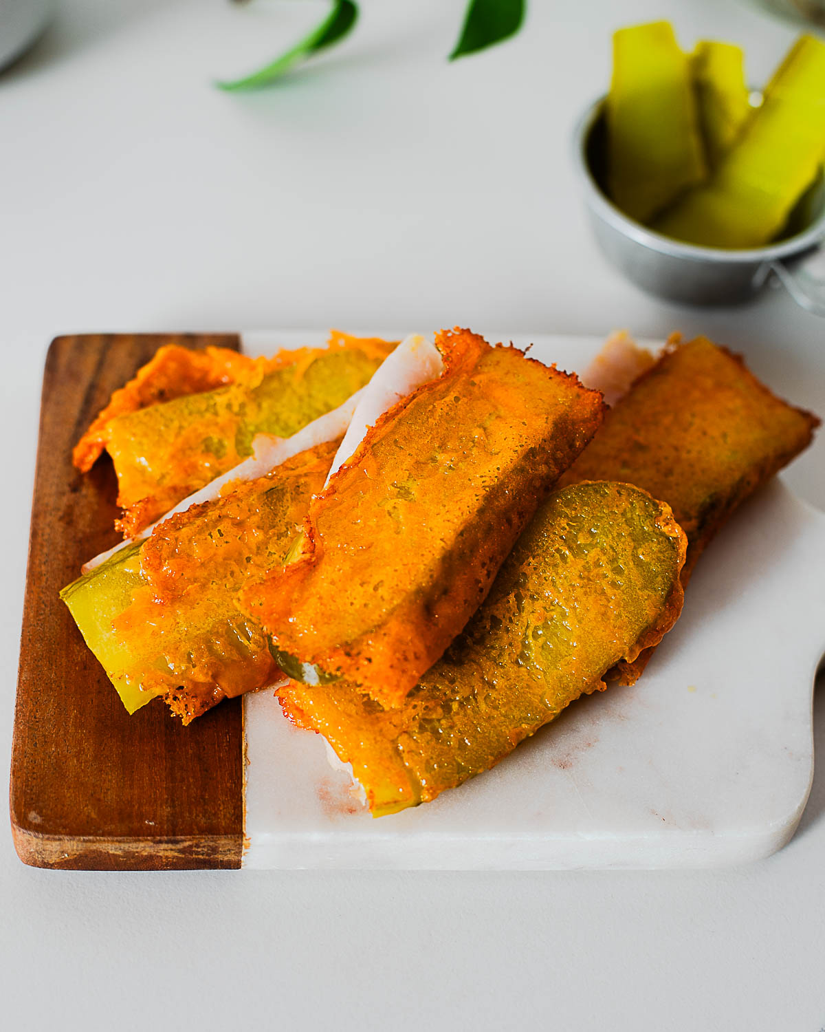 Close-up of golden crunchy cheese crisp folded around pickle and turkey