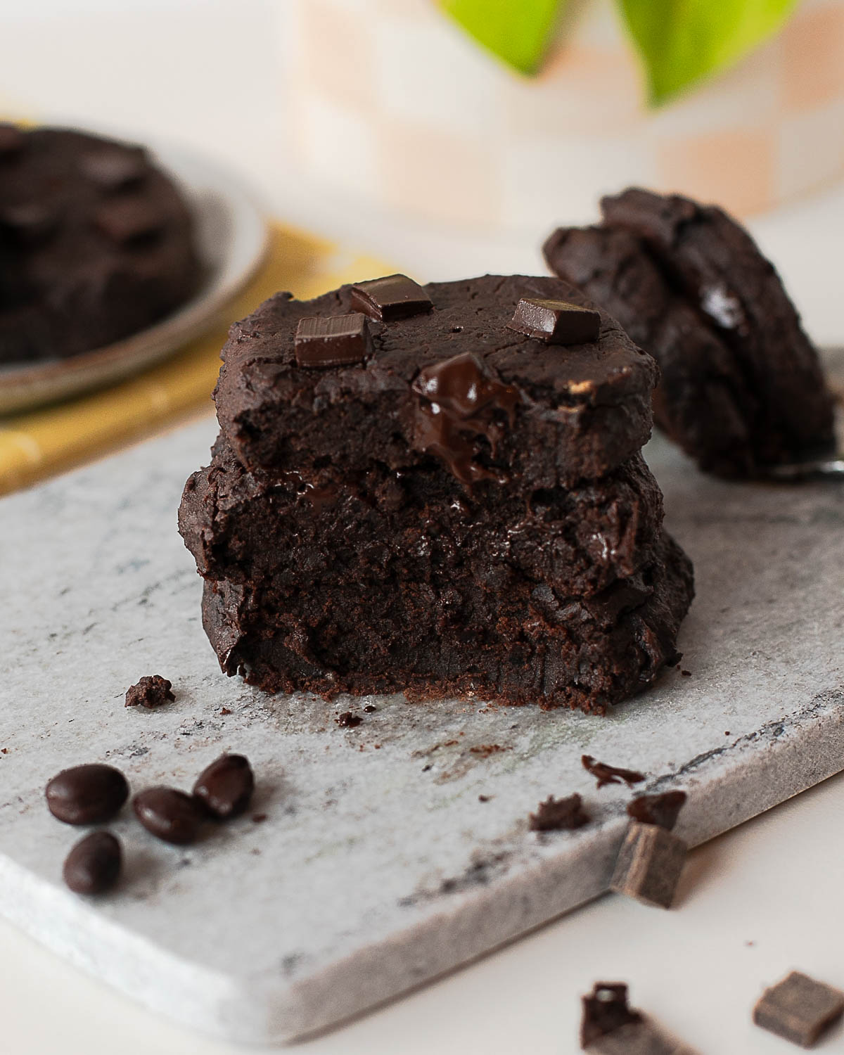 Fudgy black bean cookie broken open showing gooey chocolate center