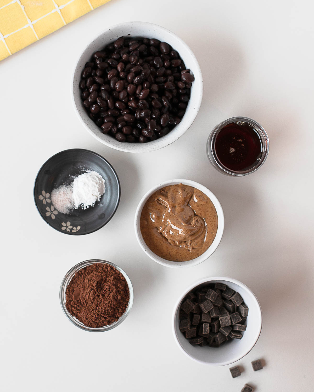 Ingredients for black bean cookies including black beans, almond butter, cocoa powder, and chocolate chips