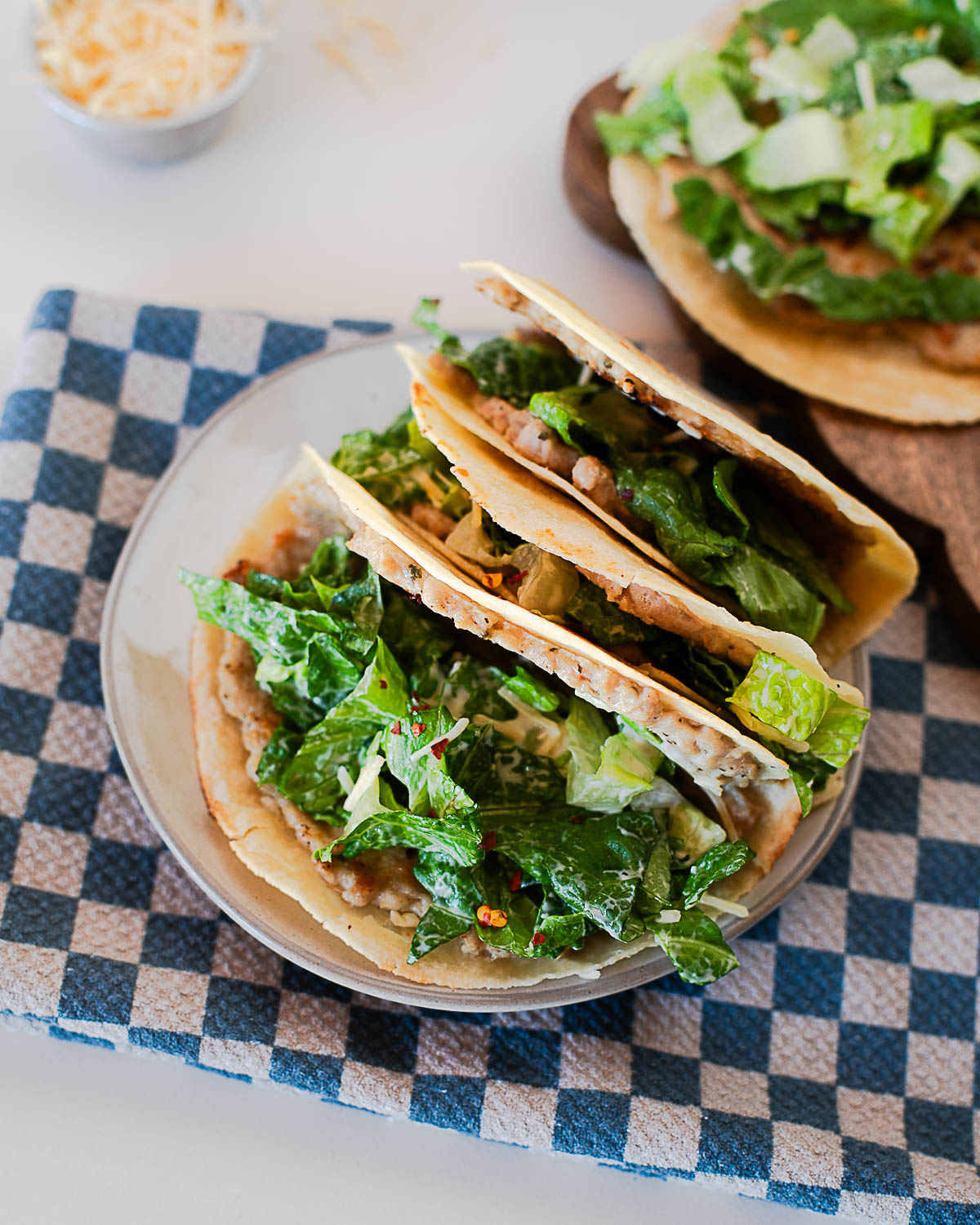 High-protein chicken caesar smash tacos served with creamy caesar salad and parmesan.