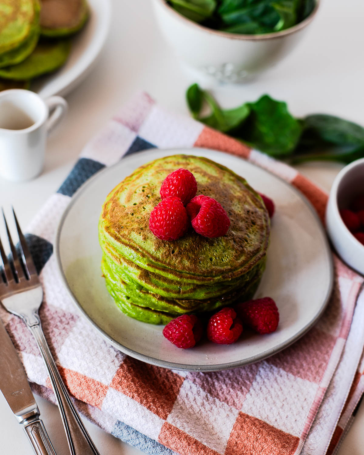 Stack of spinach einkorn pancakes served for a healthy breakfast