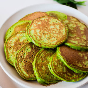 Close-up of fluffy green pancakes made with spinach and einkorn flour