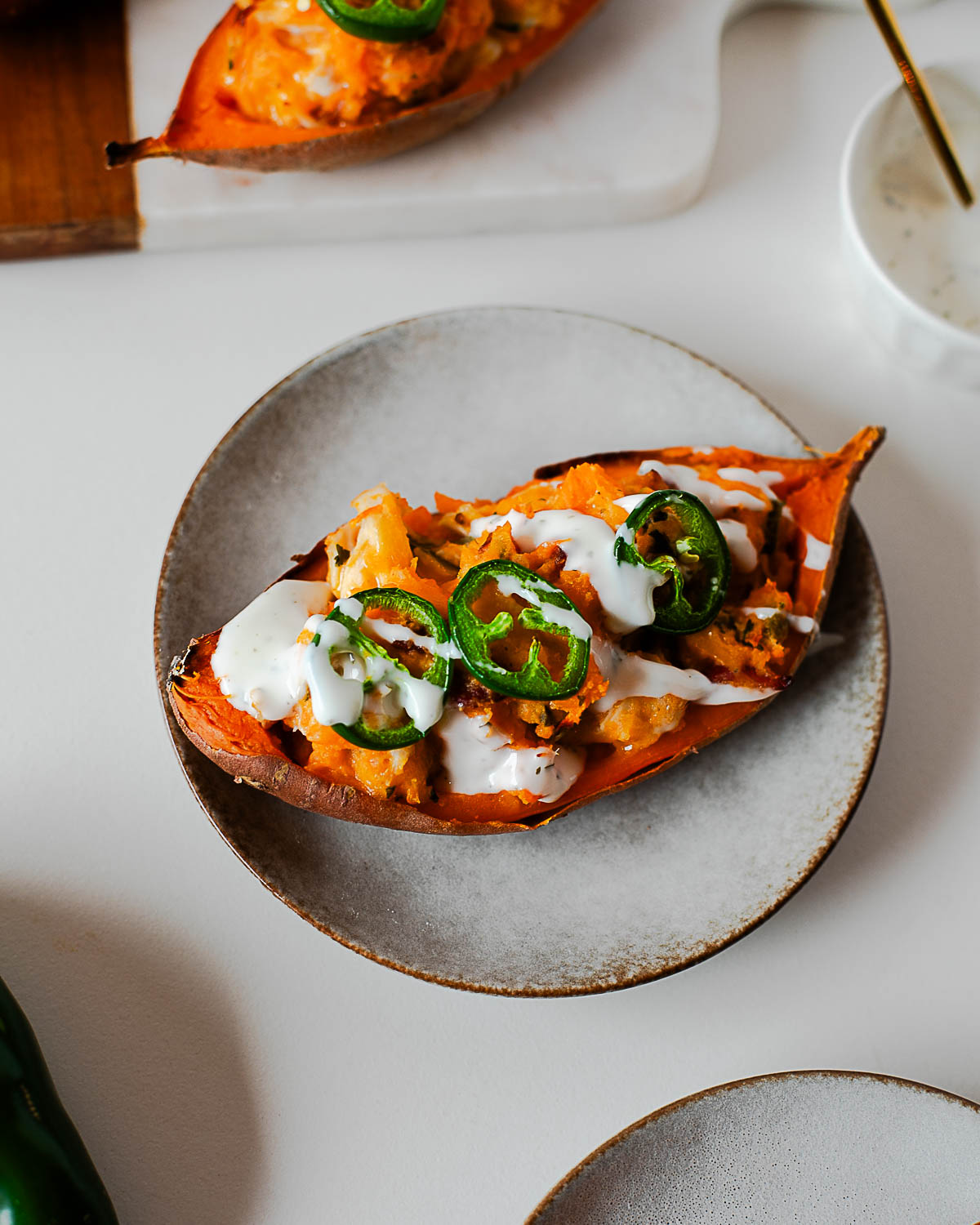 High protein loaded sweet potato served on plate with sauce drizzle
