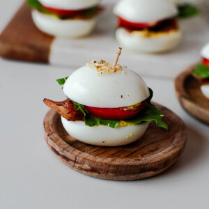BLT deviled egg sliders topped with everything bagel seasoning and secured with toothpicks