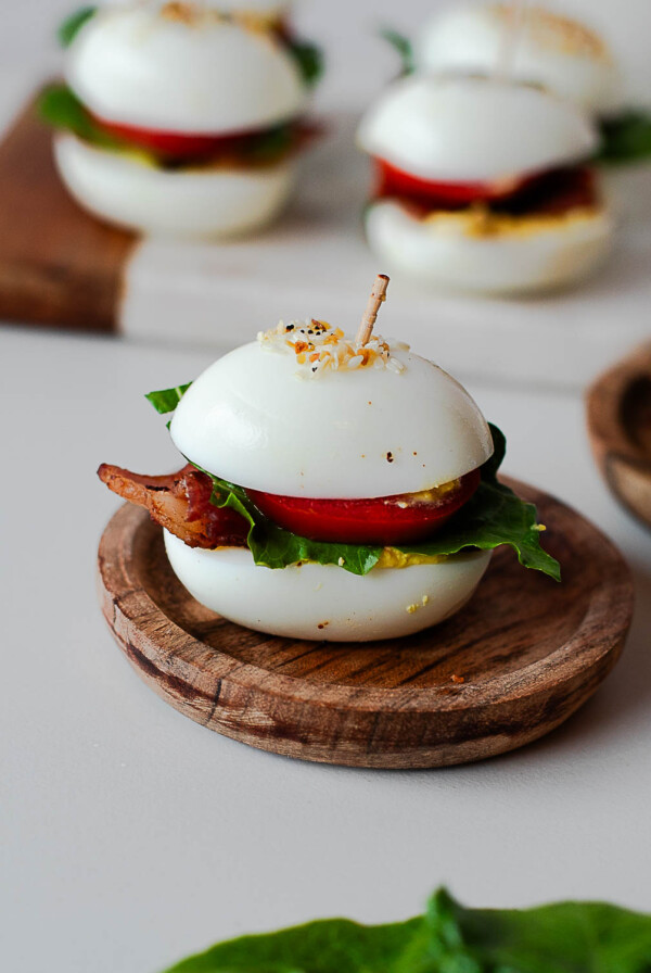 BLT deviled egg sliders topped with everything bagel seasoning and secured with toothpicks