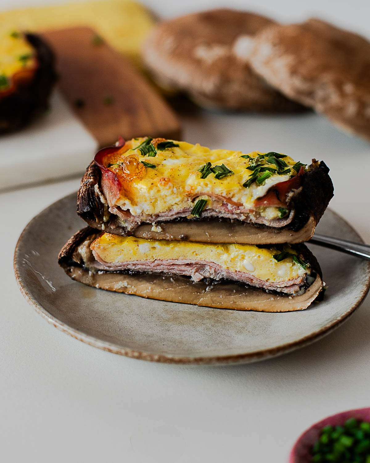 Stacked slices of egg stuffed portobello mushrooms showing meaty mushroom base and protein-packed filling
