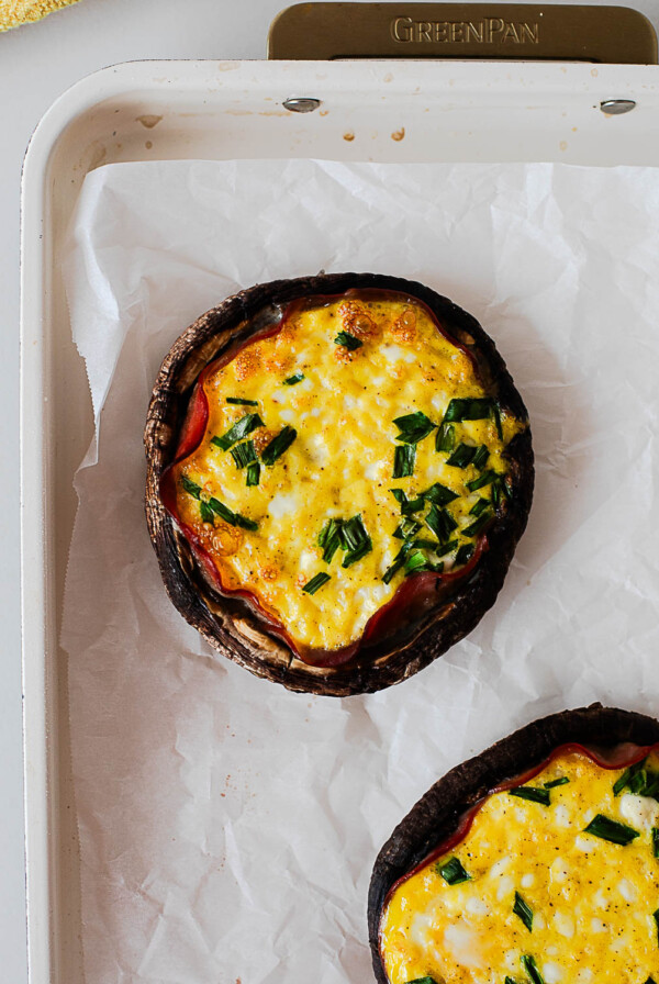 Baked breakfast stuffed portobello mushrooms with set eggs, cottage cheese, and fresh chives