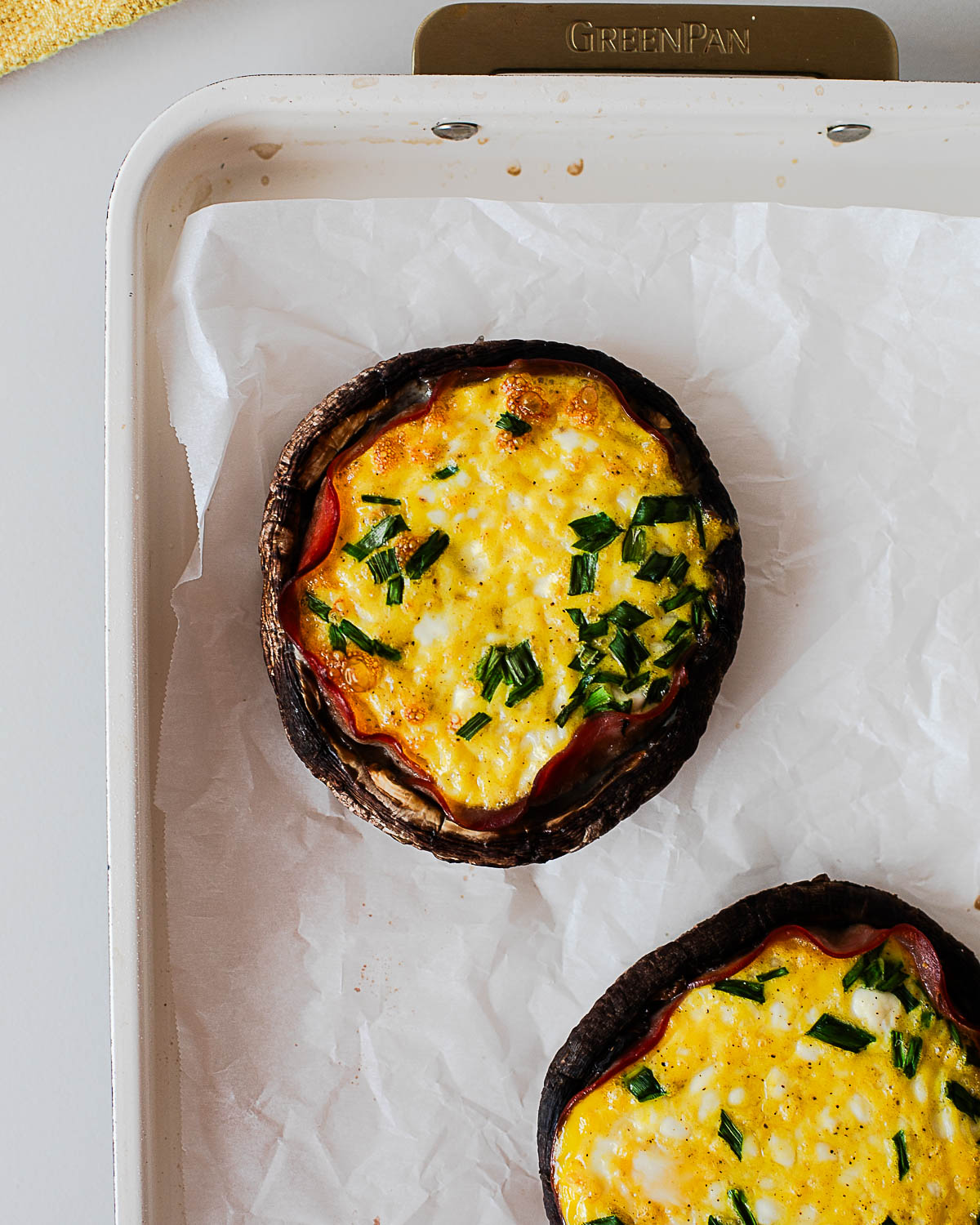 Baked breakfast stuffed portobello mushrooms with set eggs, cottage cheese, and fresh chives