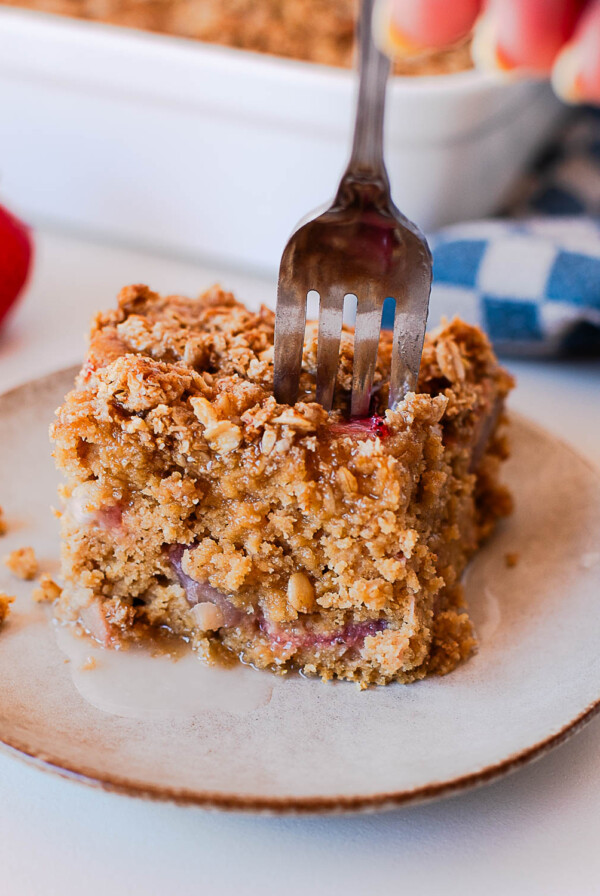 Strawberry coffee cake slice with crumb topping and fresh strawberries inside