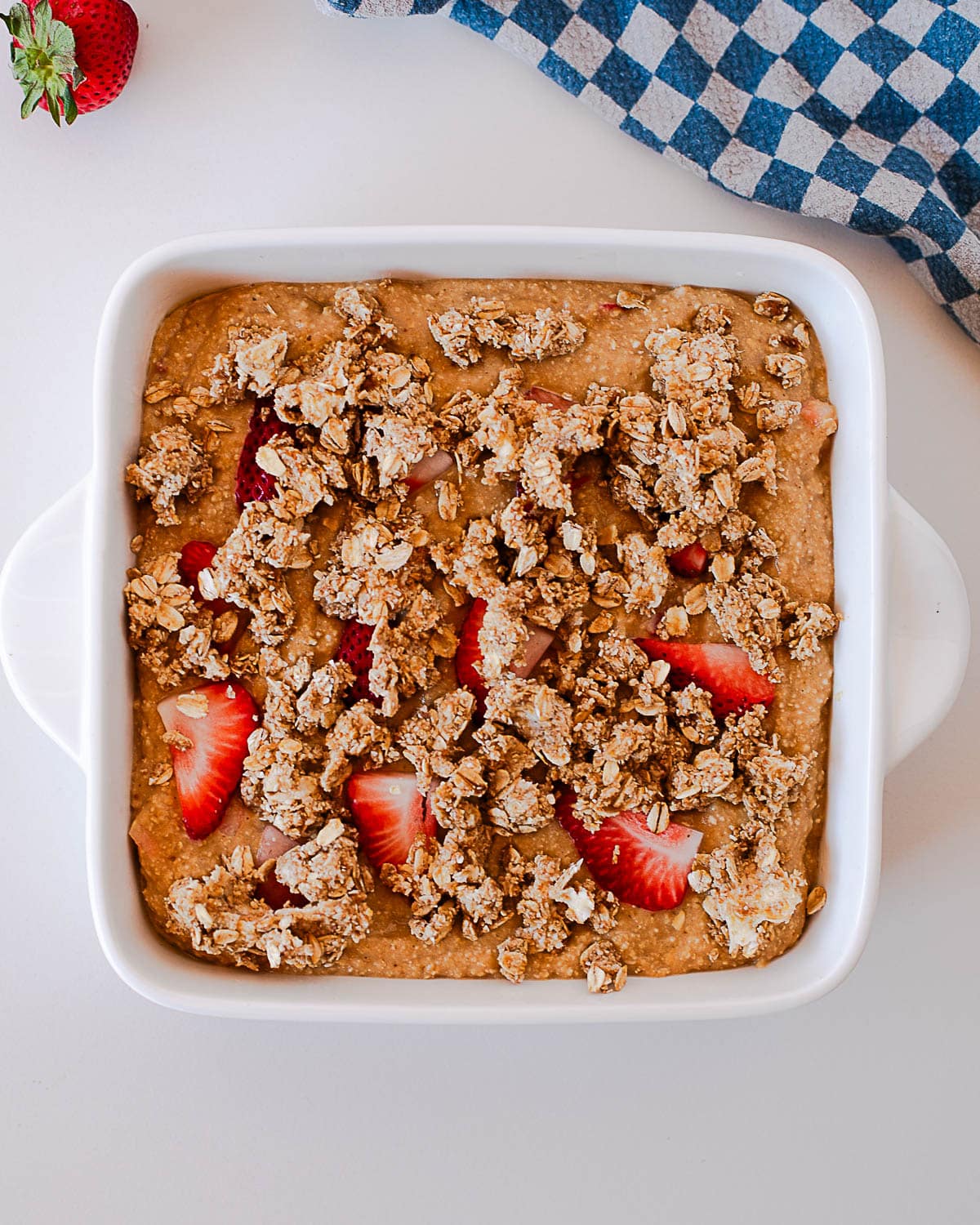 Unbaked strawberry crumb coffee cake with crumble topping added before baking