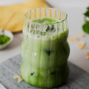 High protein iced coconut matcha latte made with ceremonial grade matcha powder, coconut milk, and vanilla protein powder.