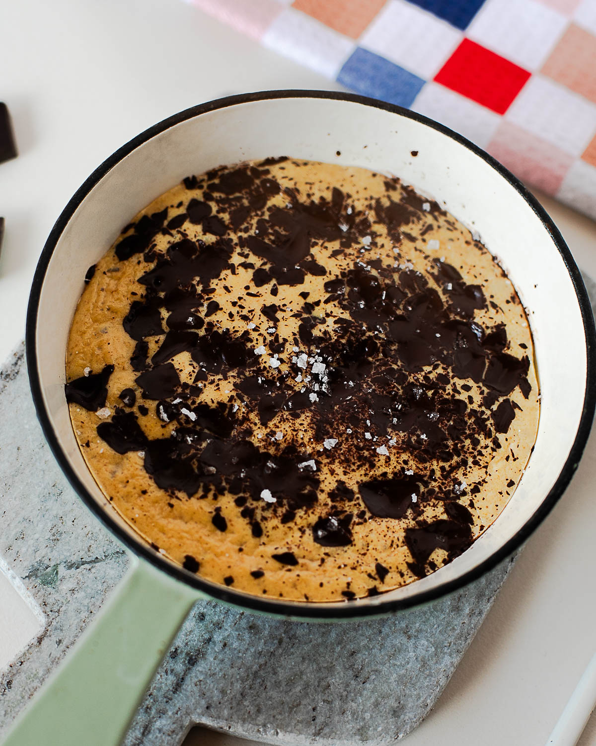 Healthy protein skillet cookie recipe baked until golden with melted dark chocolate and soft gooey center.