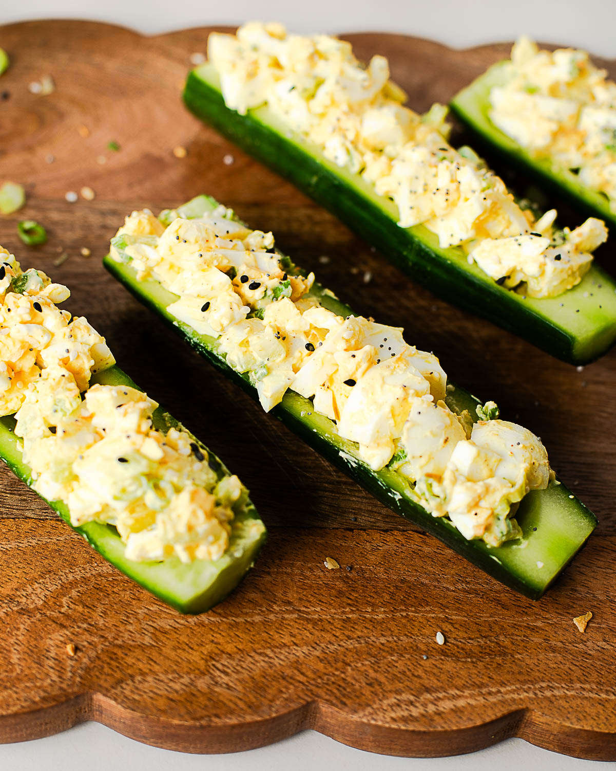 Close-up of creamy egg salad cucumber boats made with hard-boiled eggs, Greek yogurt, celery, and green onions, served as an easy low-carb, high-protein lunch.
