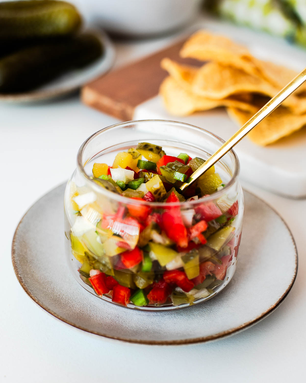 Pickle de gallo stored in a glass container for meal prep, showing the colorful mix of crunchy pickles and fresh vegetables.
