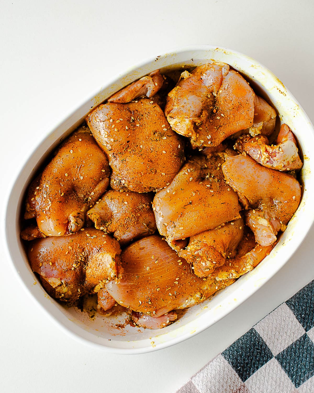 Boneless skinless chicken thighs coated in za’atar, turmeric, olive oil, salt, and black pepper before marinating.