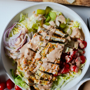 Overhead shot of chicken cutlet bowl drizzled with homemade burger sauce